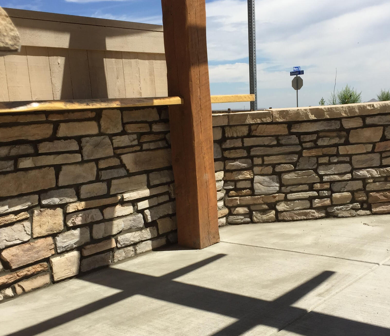 Stone walls with a live edge countertop and 8x8 hand hewn post