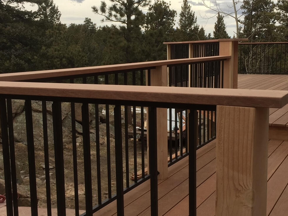 Hardwood top cap with metal vertical railing supported by fir posts- hardwood decking
