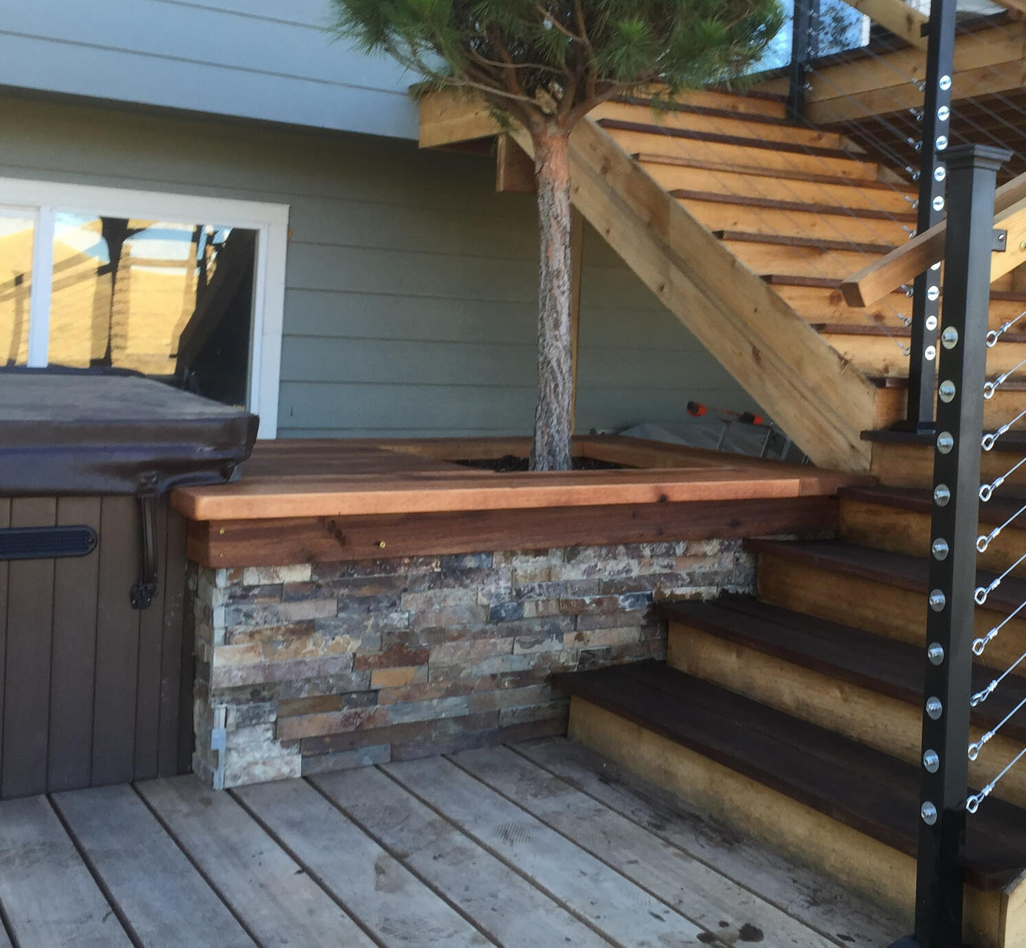 Stacked stone veneer wrapping a tanyosha pine, wood and metal accents
